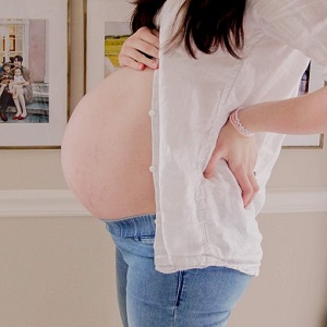 A woman shows her baby bump